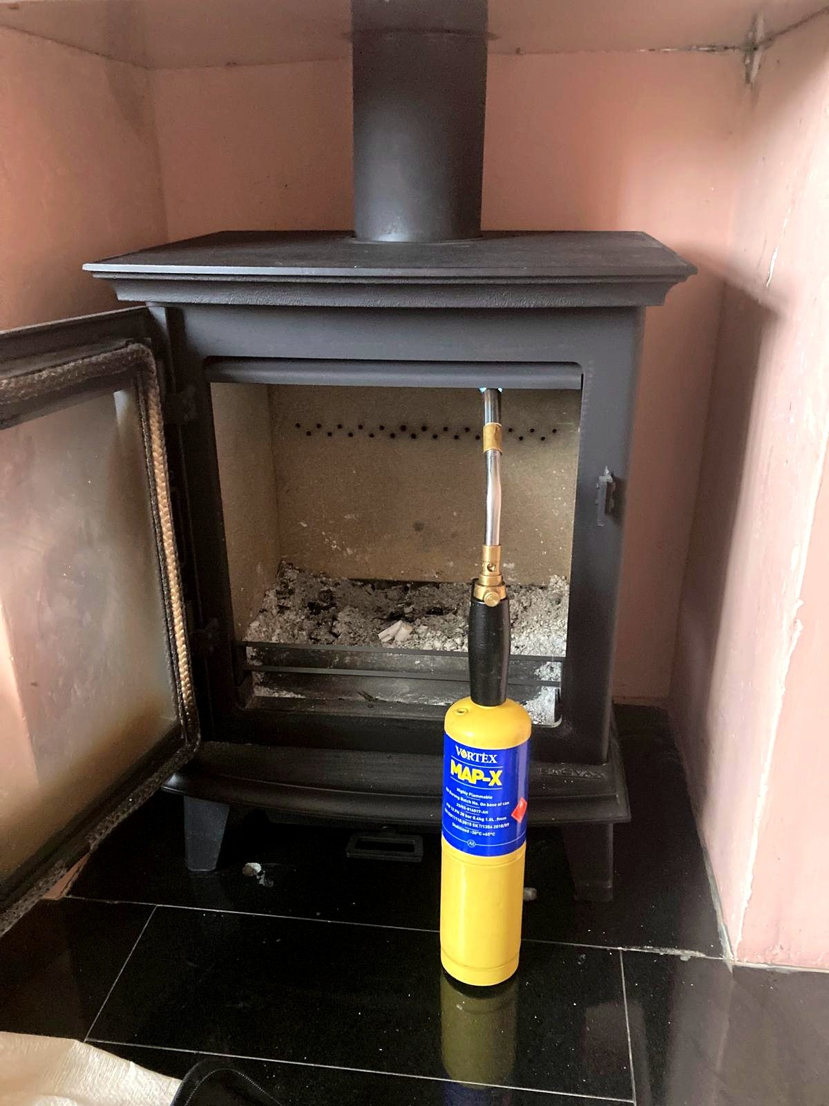 An EmberCraft engineer servicing a gas stove during an annual maintenance visit in Kent