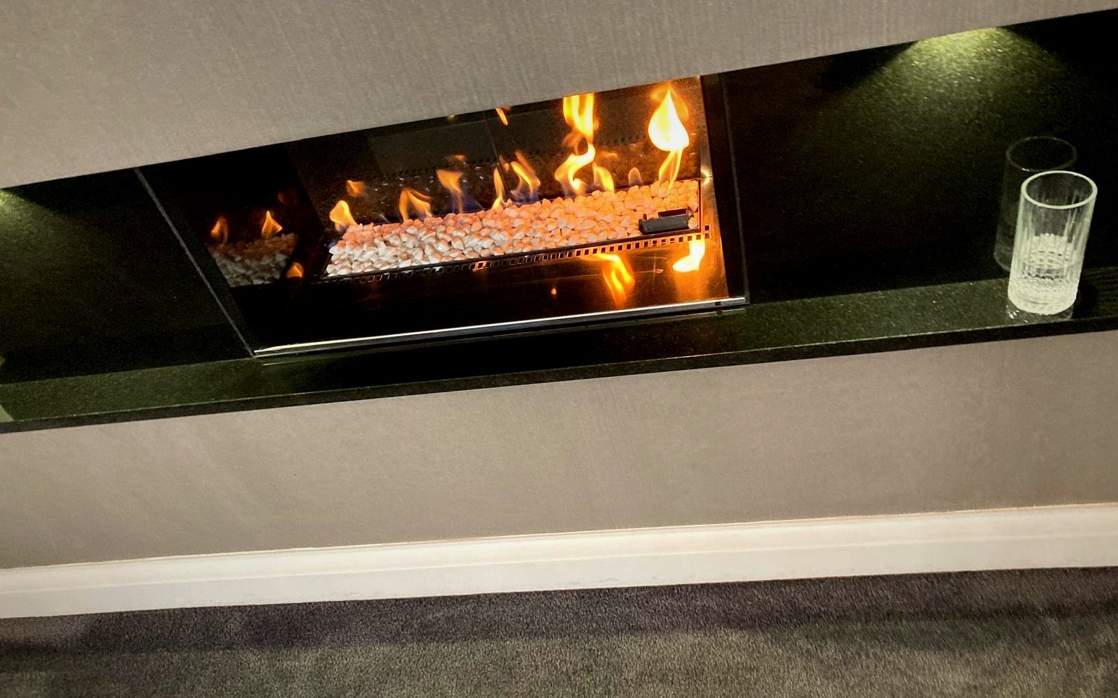 A linear gas fire on black granite installed by EmberCraft, serving Deal, Kent