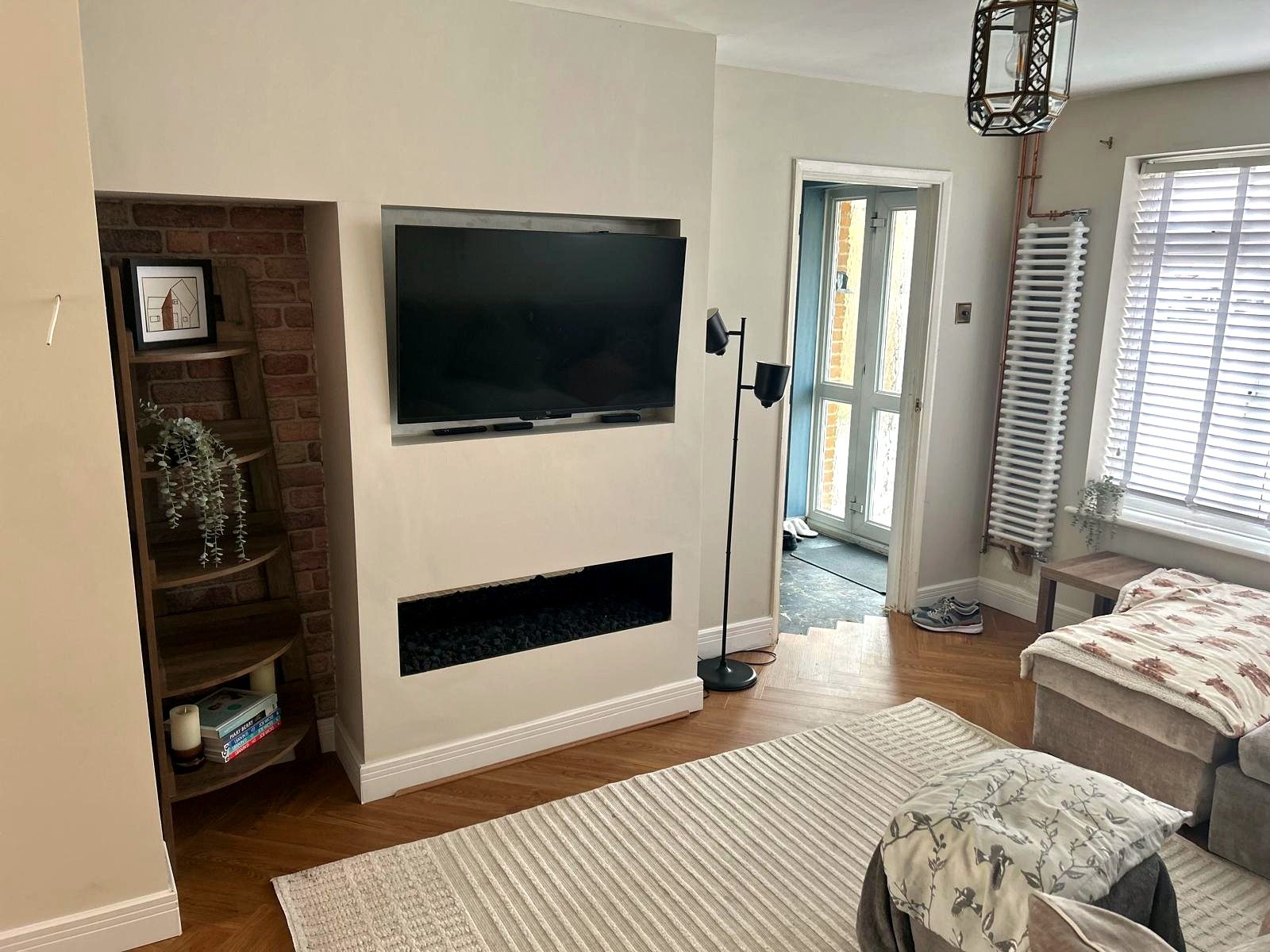 A built-in media wall with a recessed TV and a linear fire