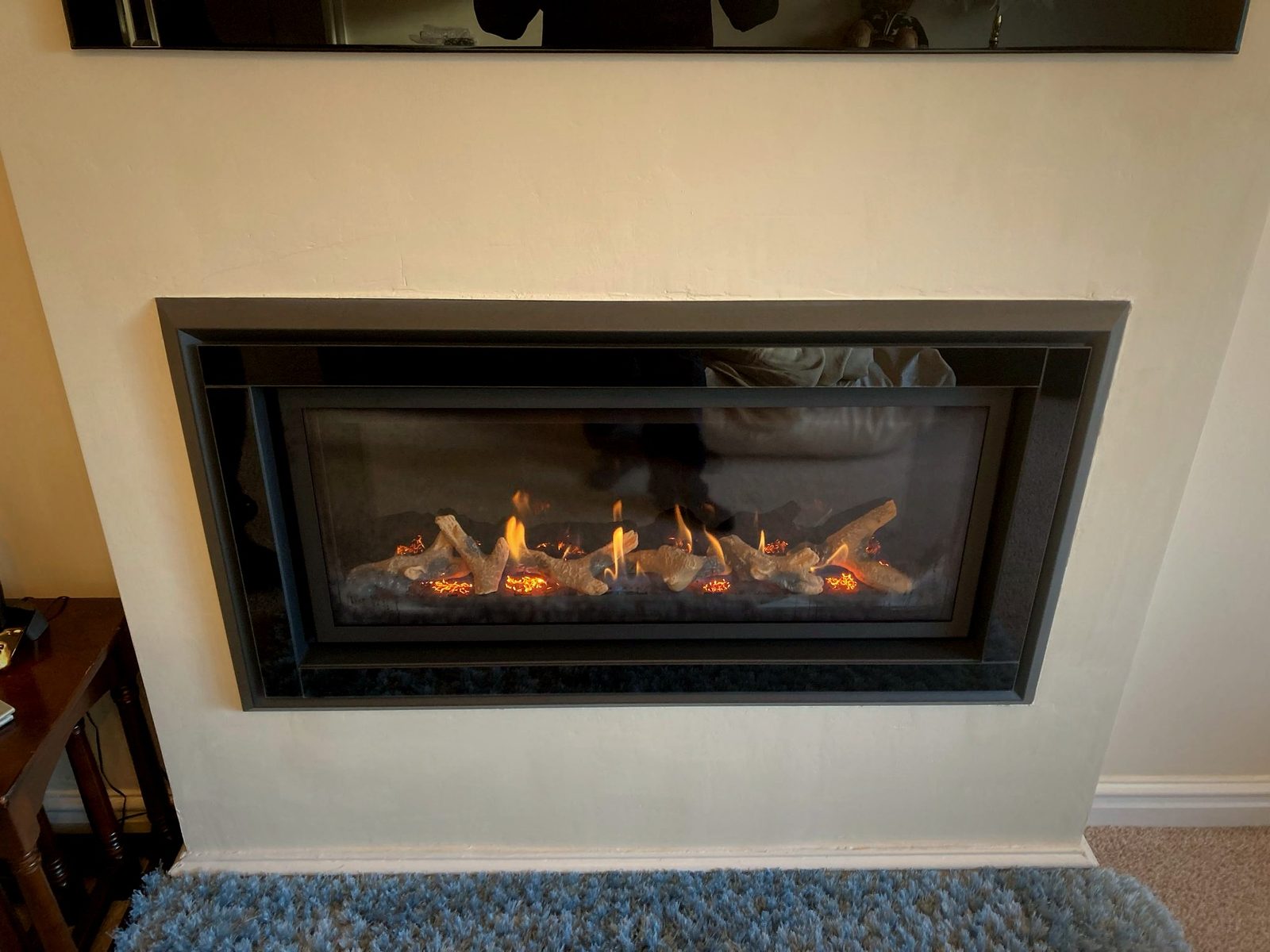A widescreen inset gas fire with a contemporary surround